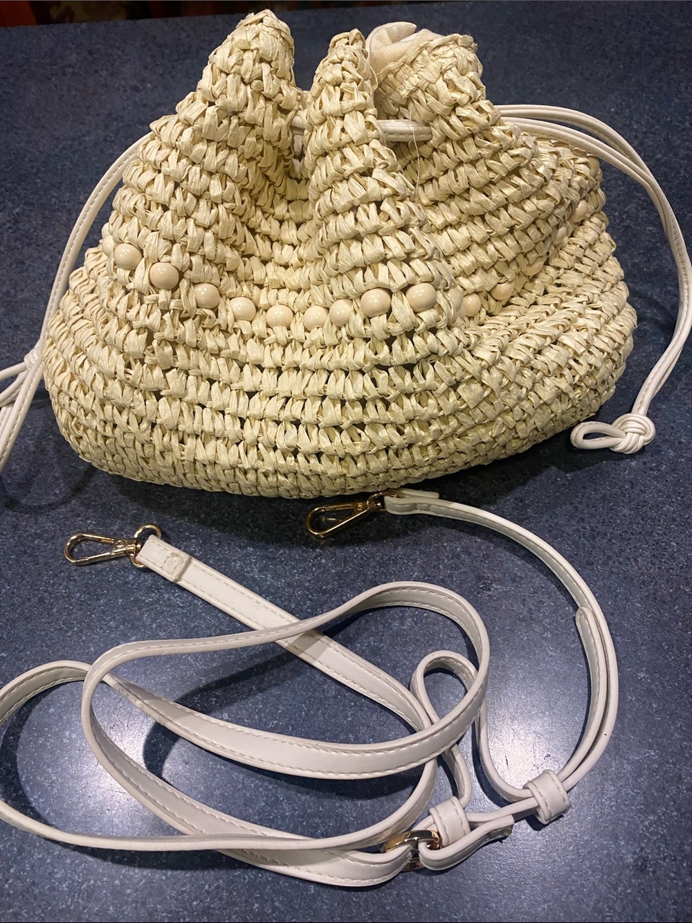 Woven Straw Drawstring Crossbody Bag in Cream